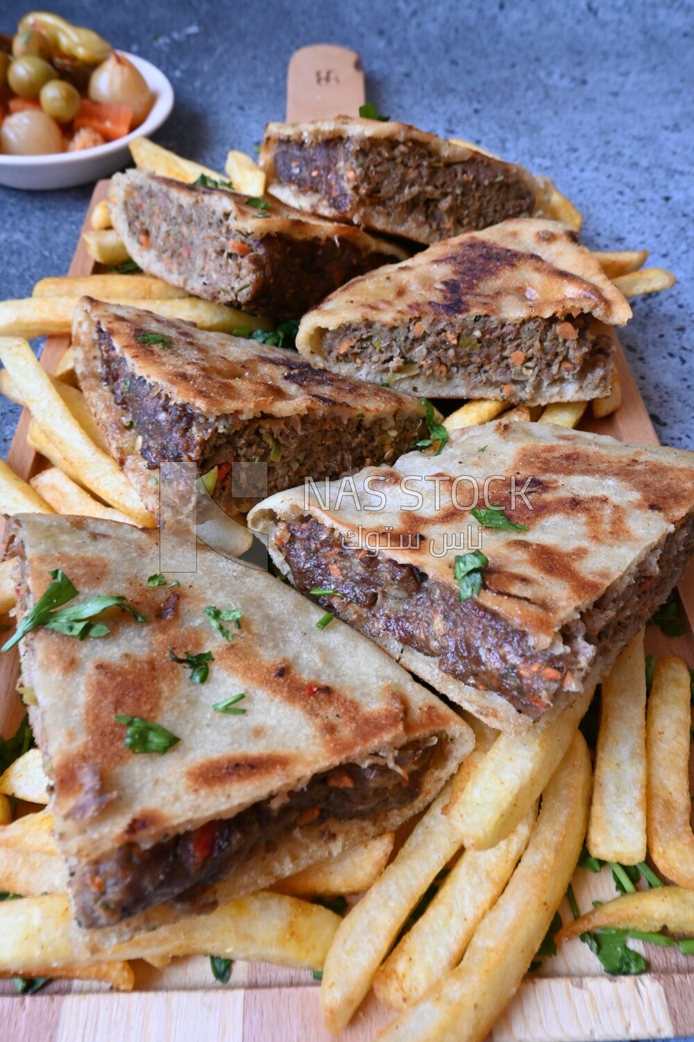 dish with hawawshi on it with fries