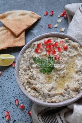 plate of lebanese baba ghanouj with bread and green pepper