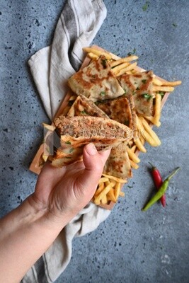 hand holding a hawawshi sandwich