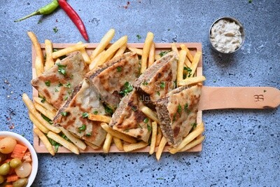 dish with hawawshi on it with fries.