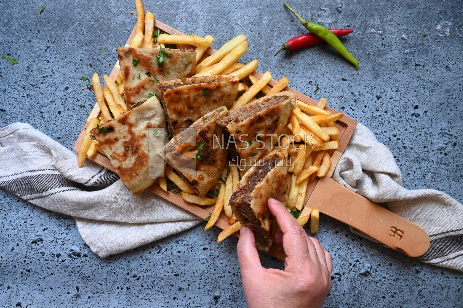 hand holding a hawawshi sandwich