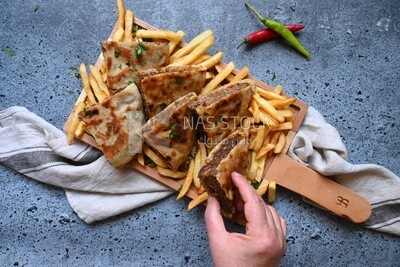 hand holding a hawawshi sandwich