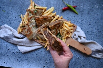 hand holding a hawawshi sandwich