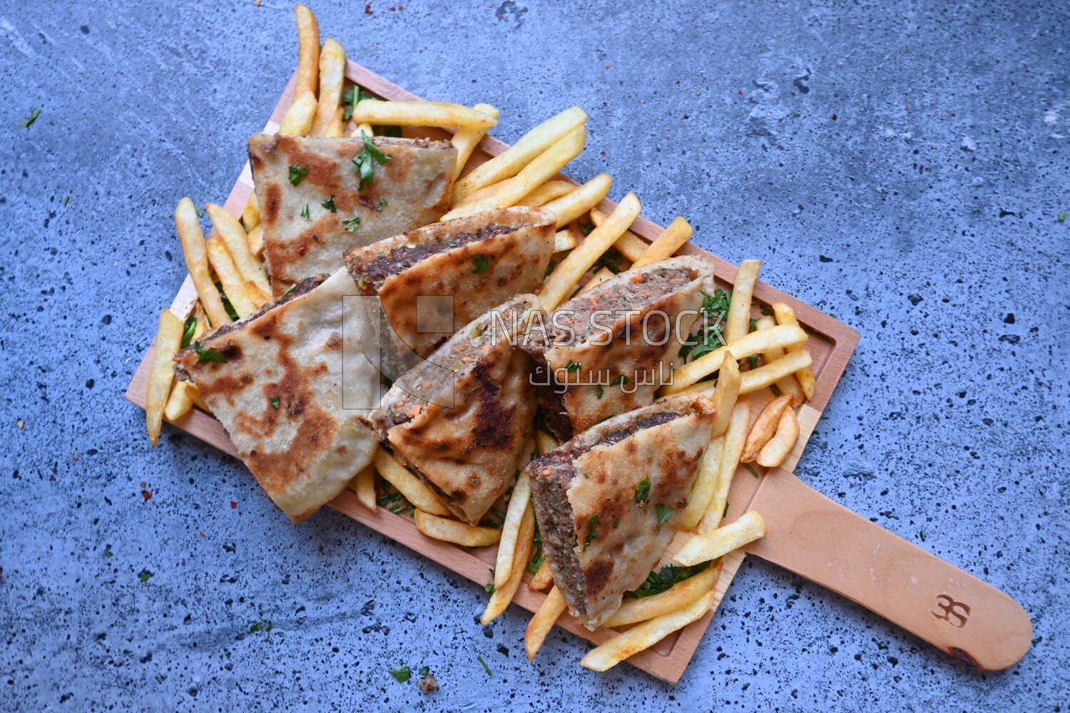 dish with hawawshi on it with fries