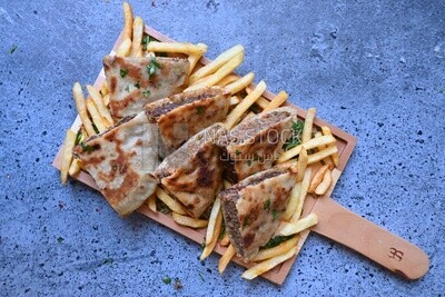 dish with hawawshi on it with fries