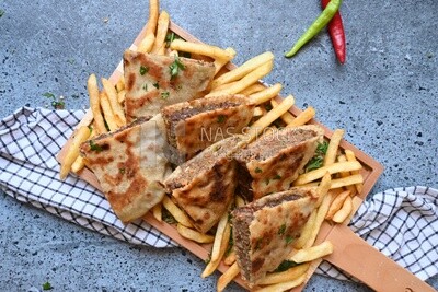 dish with hawawshi next to spicy pepper and fries