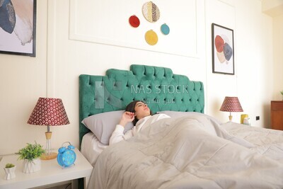 a woman sleeping in bed looks tired