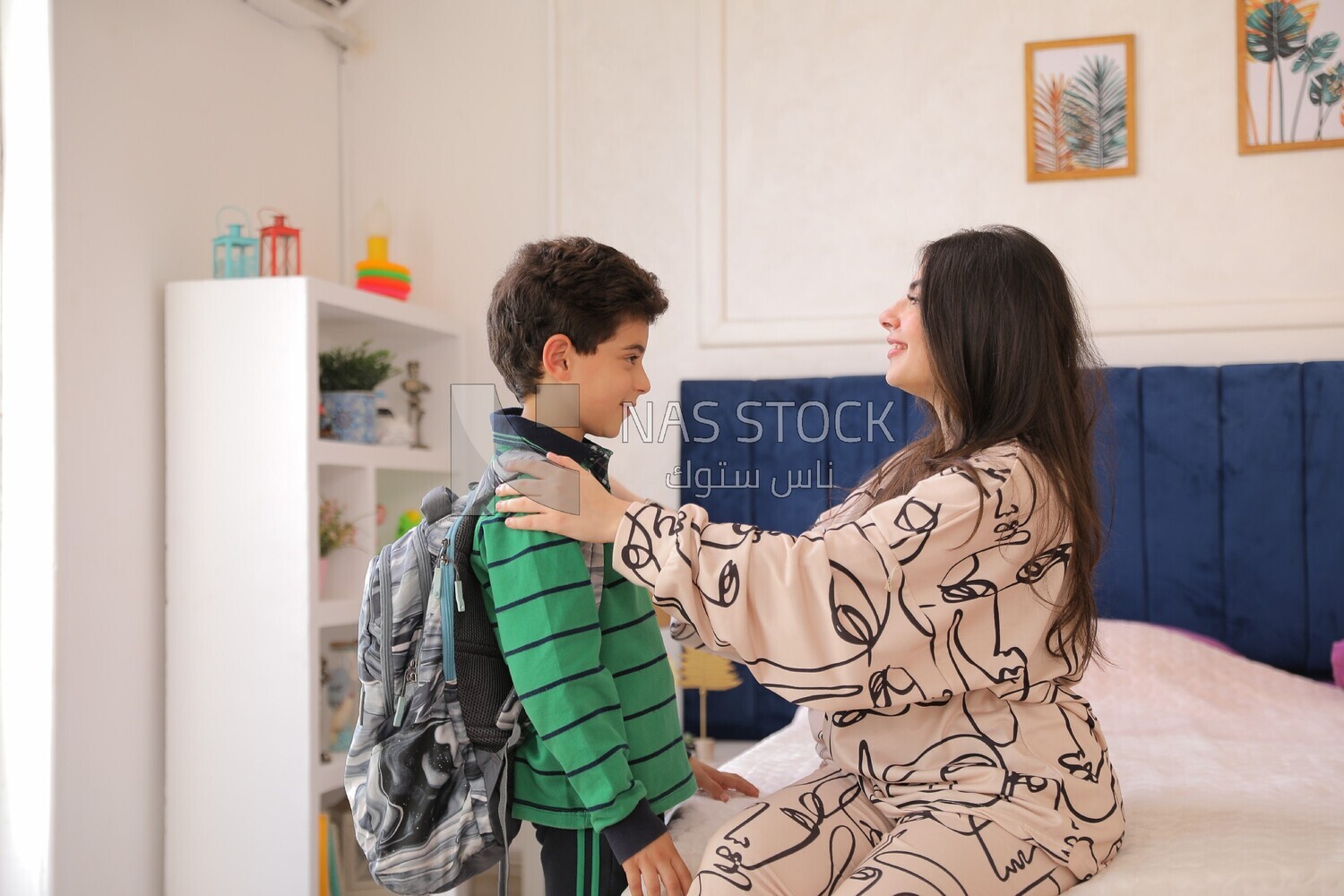 a mother gets her son ready for school