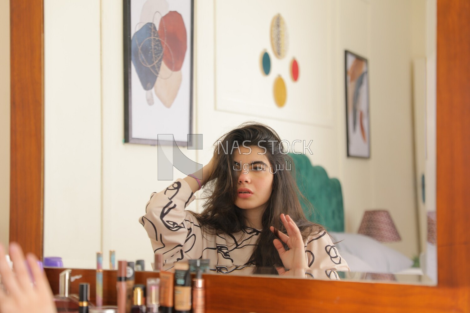 a woman sitting in front of the mirror