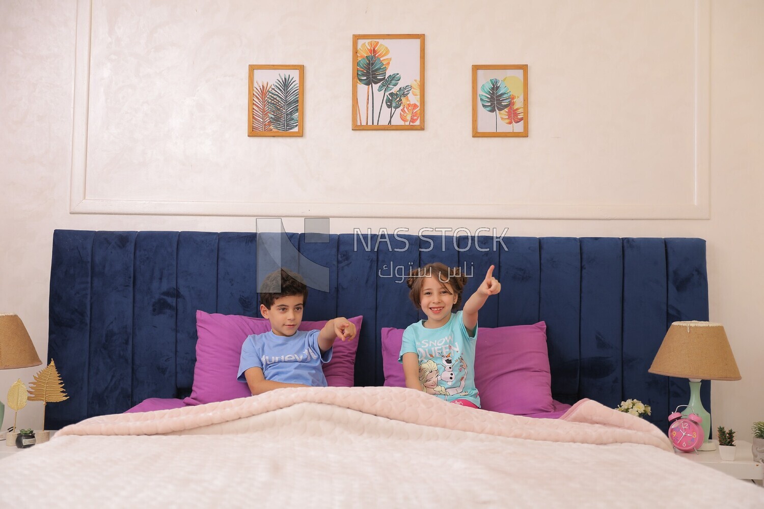 a brother and his sister lying in bed