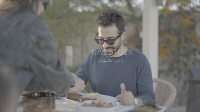 a family preparing a dining table in the garden