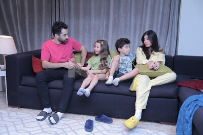 a family of four watching television