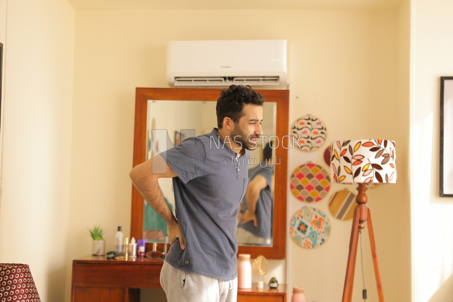 a man in a bedroom looks tired