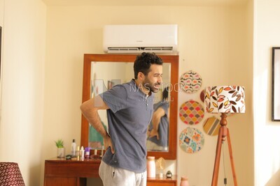 a man in a bedroom looks tired