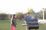 man preparing food on a barbecue grill