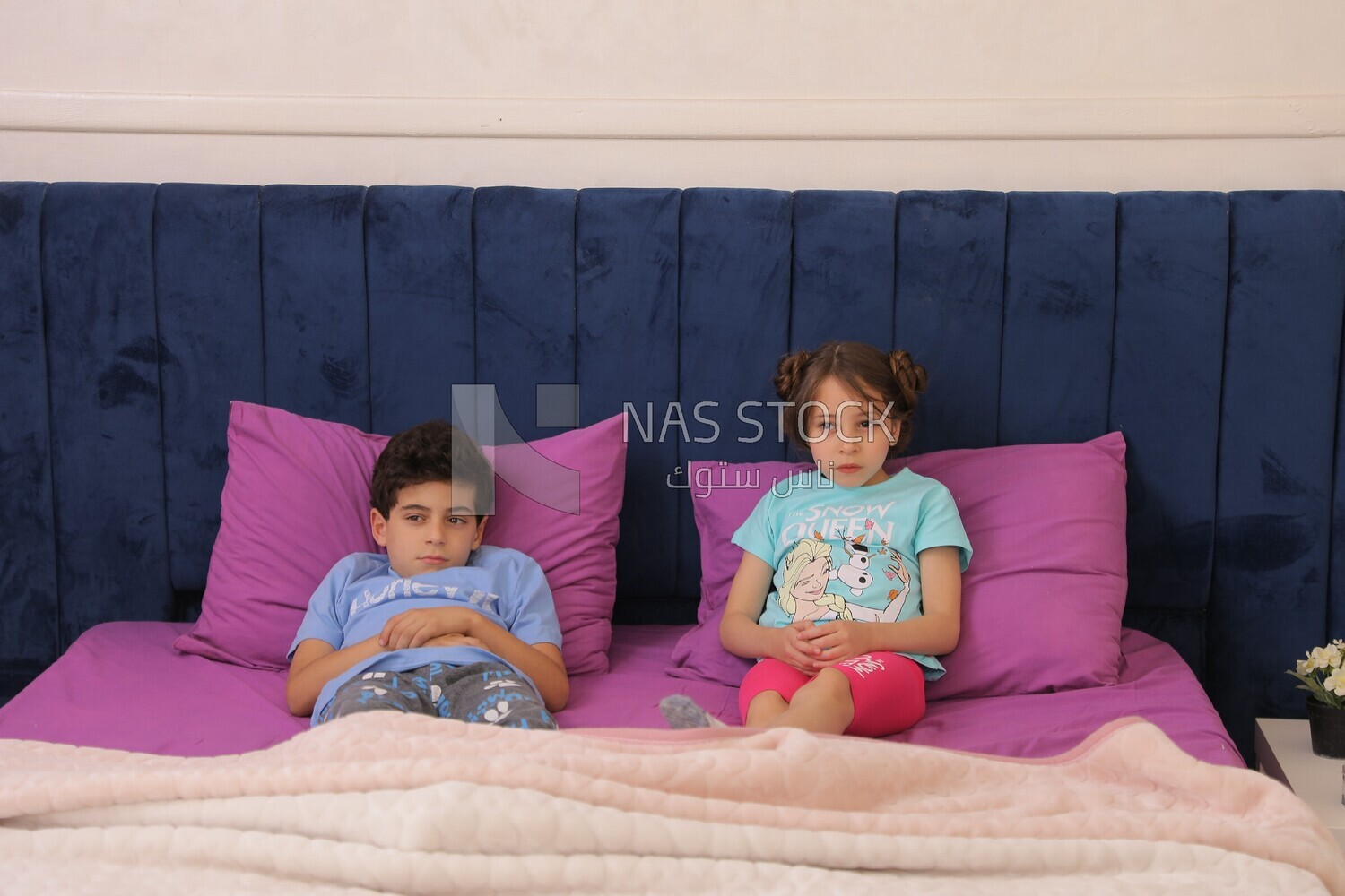 a brother and his sister lying in bed