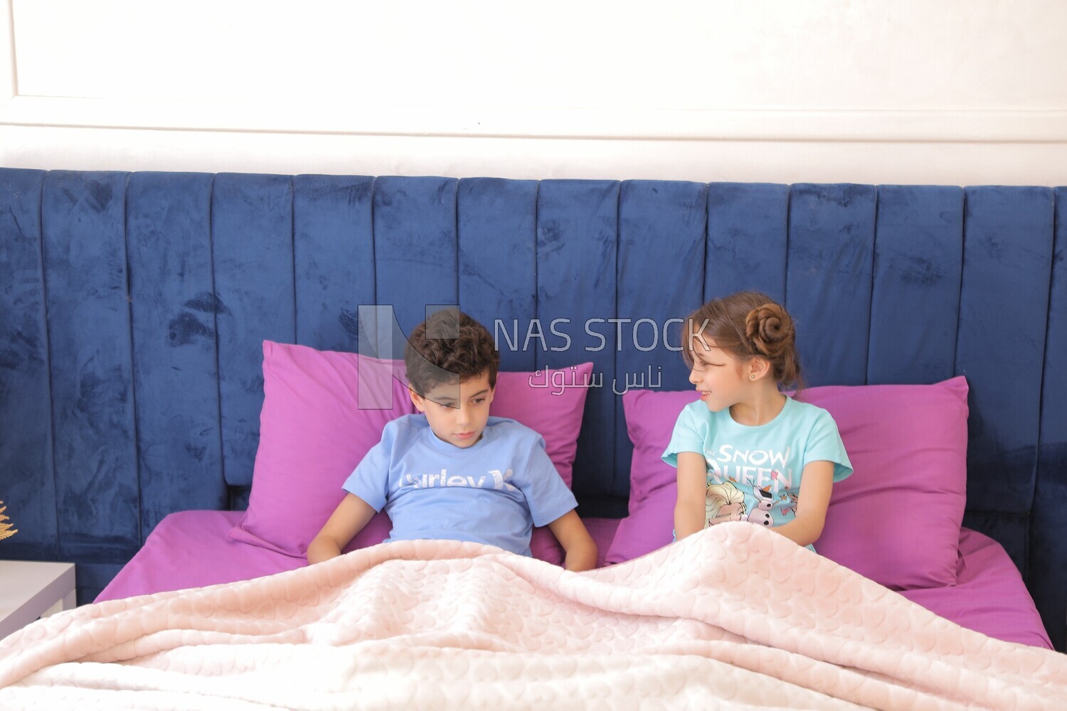 a brother and his sister lying in bed