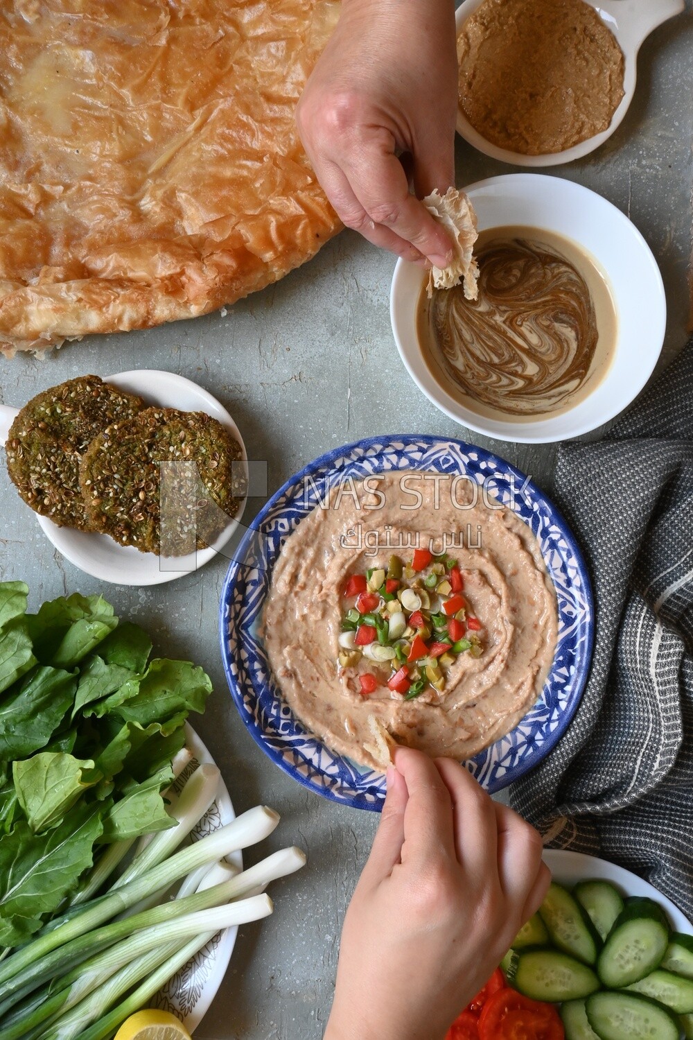 Hands eating egyptian feteer meshaltet