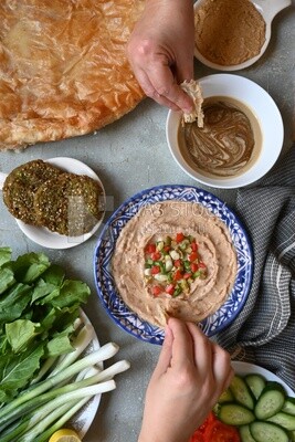 Hands eating egyptian feteer meshaltet