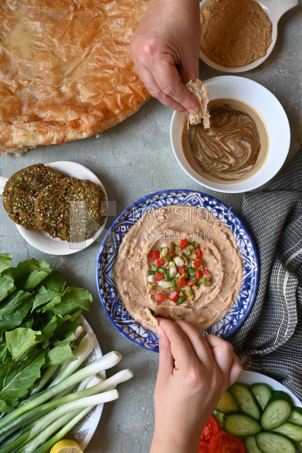 Hands eating egyptian feteer meshaltet