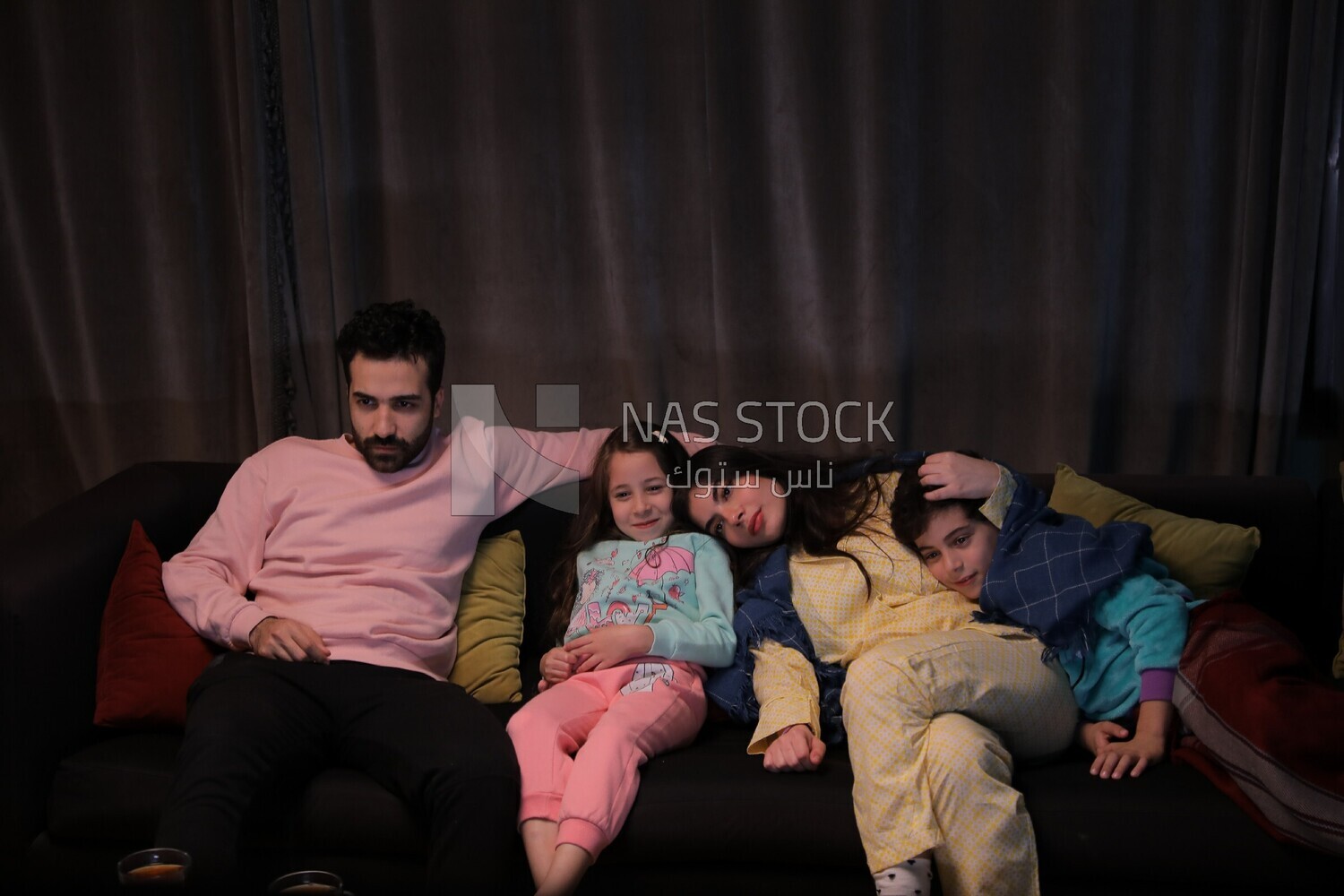 a family of four watching television