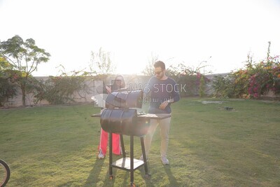 man preparing food on a barbecue grill