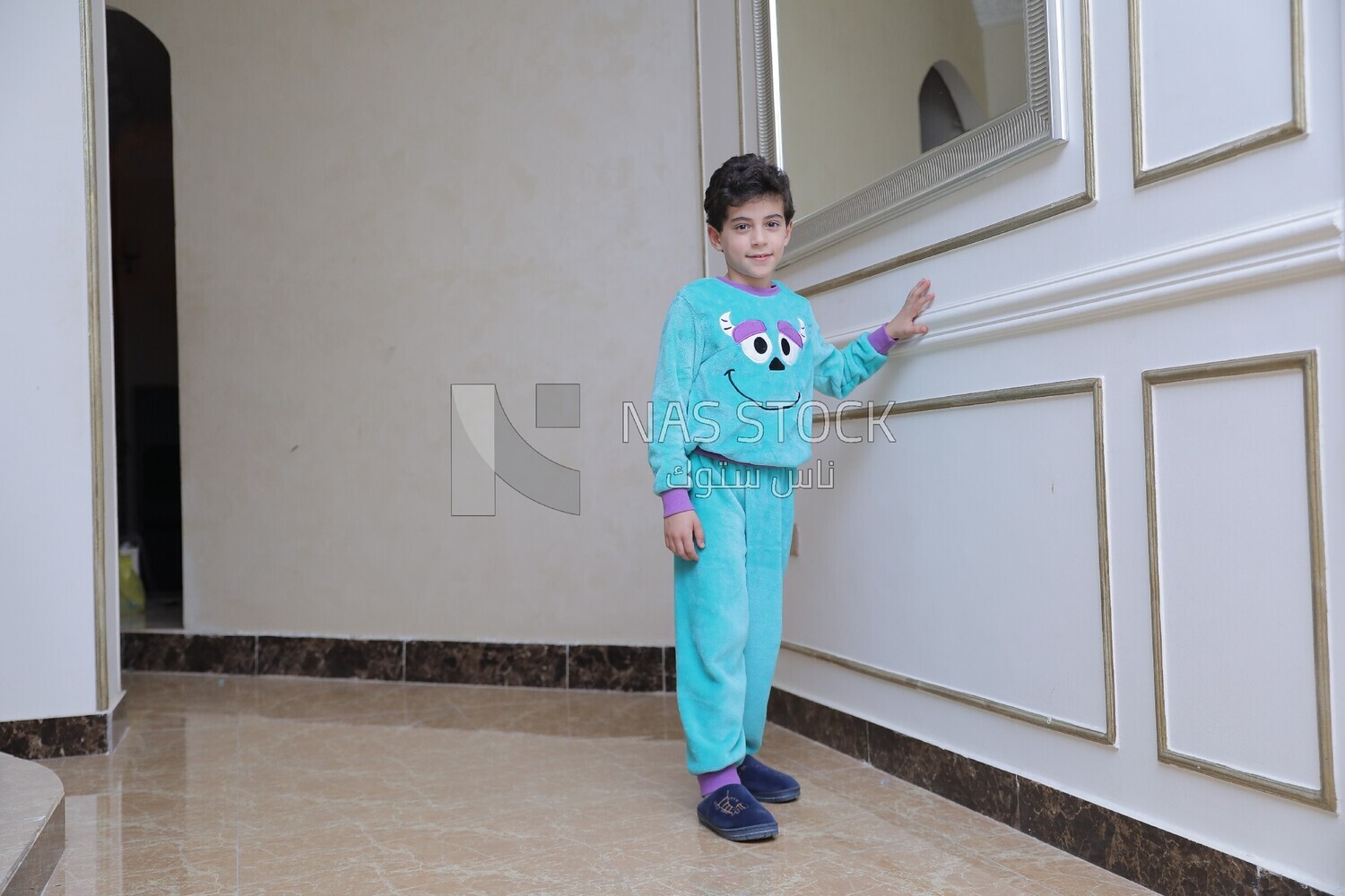 a boy standing in the living room