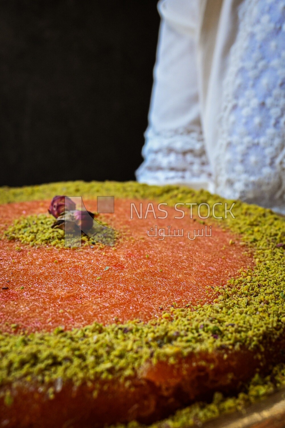 Plate of palestine knafeh with some nuts on it