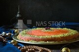 Plate of palestine knafeh with some nuts on it