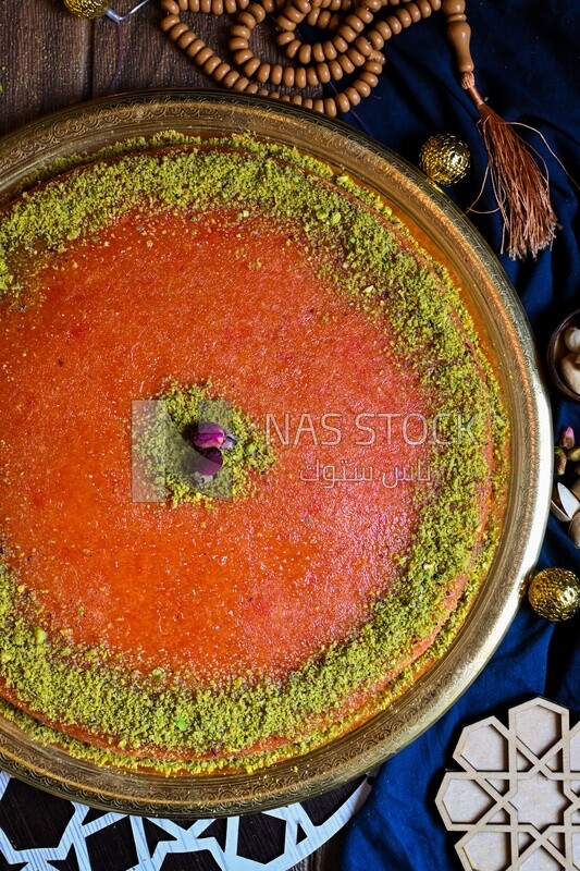 Plate of palestine knafeh with some nuts on it