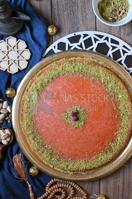 Plate of palestine knafeh with some nuts on it
