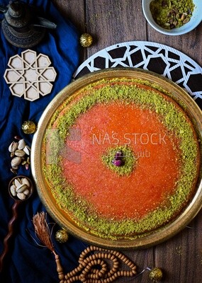Plate of palestine knafeh with some nuts on it