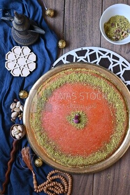 Plate of palestine knafeh with some nuts on it