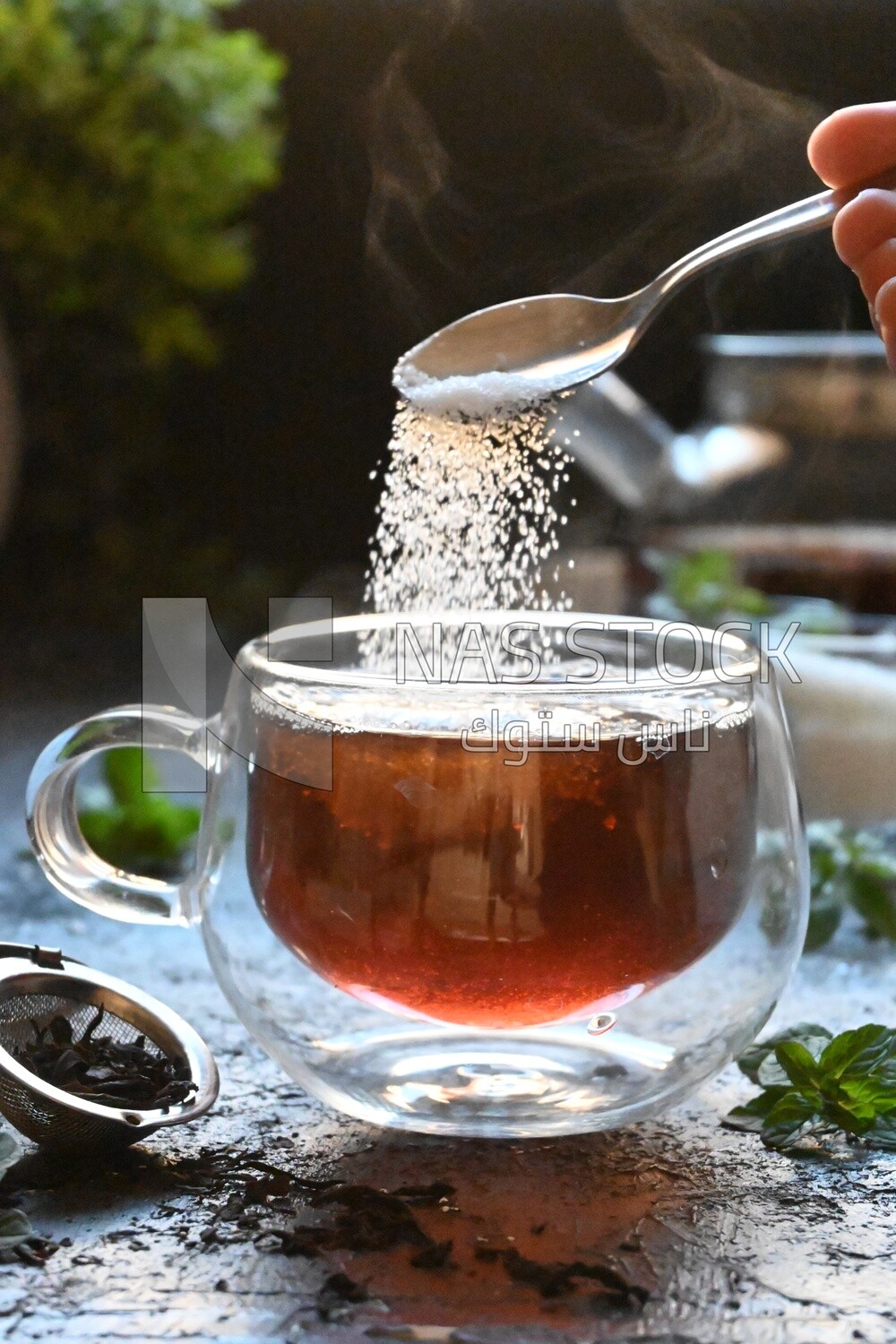 Spoon of sugar dropped on a cup of tea