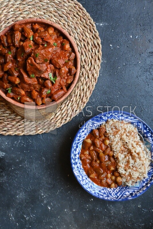 Top view of a delicious okra dish with sauce and meat, Plate rice, Arabic meals, recipes and delicious food dishes, delicious meals, delicious food, okra dish