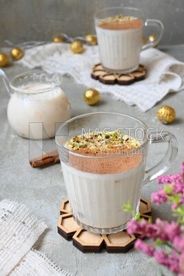 Cup of sahlab with cinnamon and nuts on it