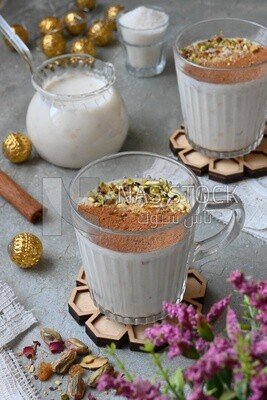 Cup of sahlab with cinnamon and nuts on it