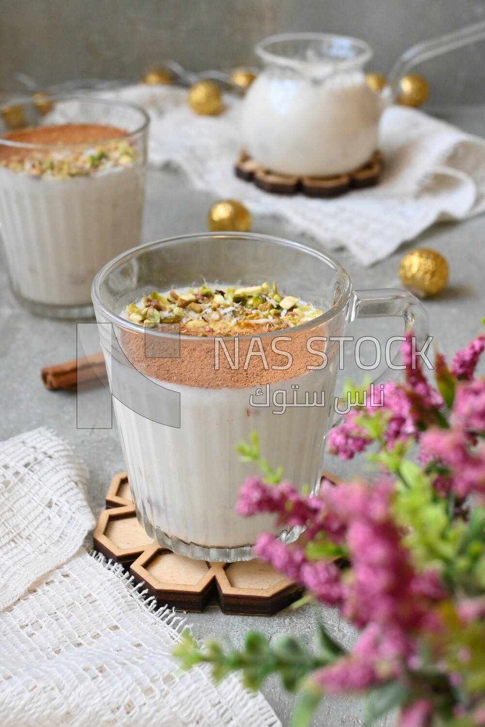 Cup of sahlab with cinnamon and nuts on it