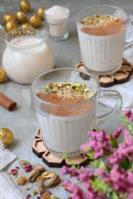 Cup of sahlab with cinnamon and nuts on it
