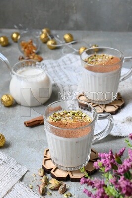 Cup of sahlab with cinnamon and nuts on it