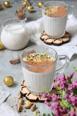Cup of sahlab with cinnamon and nuts on it
