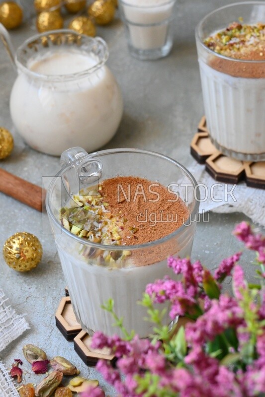 Cup of sahlab with cinnamon and nuts on it