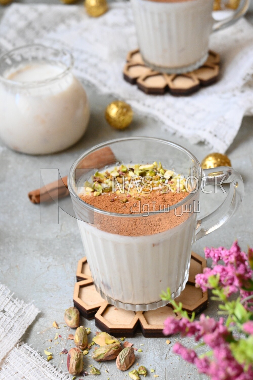 Cup of sahlab with cinnamon and nuts on it