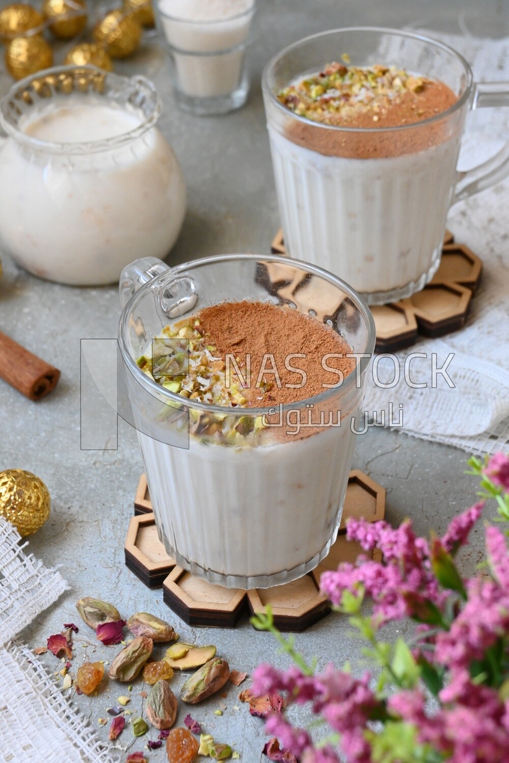 Cup of sahlab with cinnamon and nuts on it