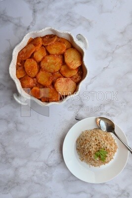 Potato tray sits beside a plate of rice