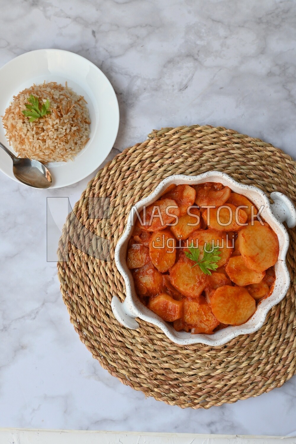 Potato tray sits beside a plate of rice