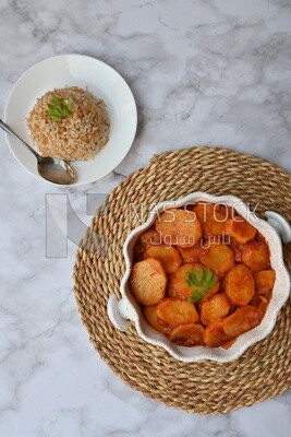 Potato tray sits beside a plate of rice