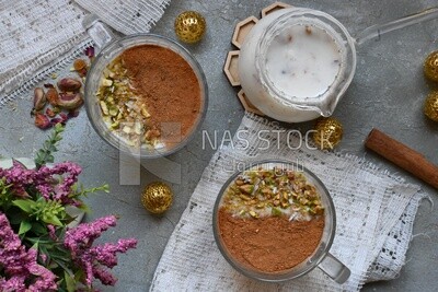 Cup of sahlab with cinnamon and nuts on it
