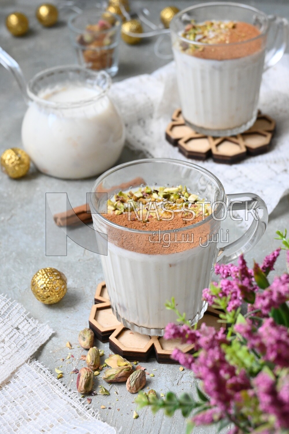 Cup of sahlab with cinnamon and nuts on it