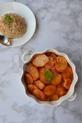 Potato tray sits beside a plate of rice